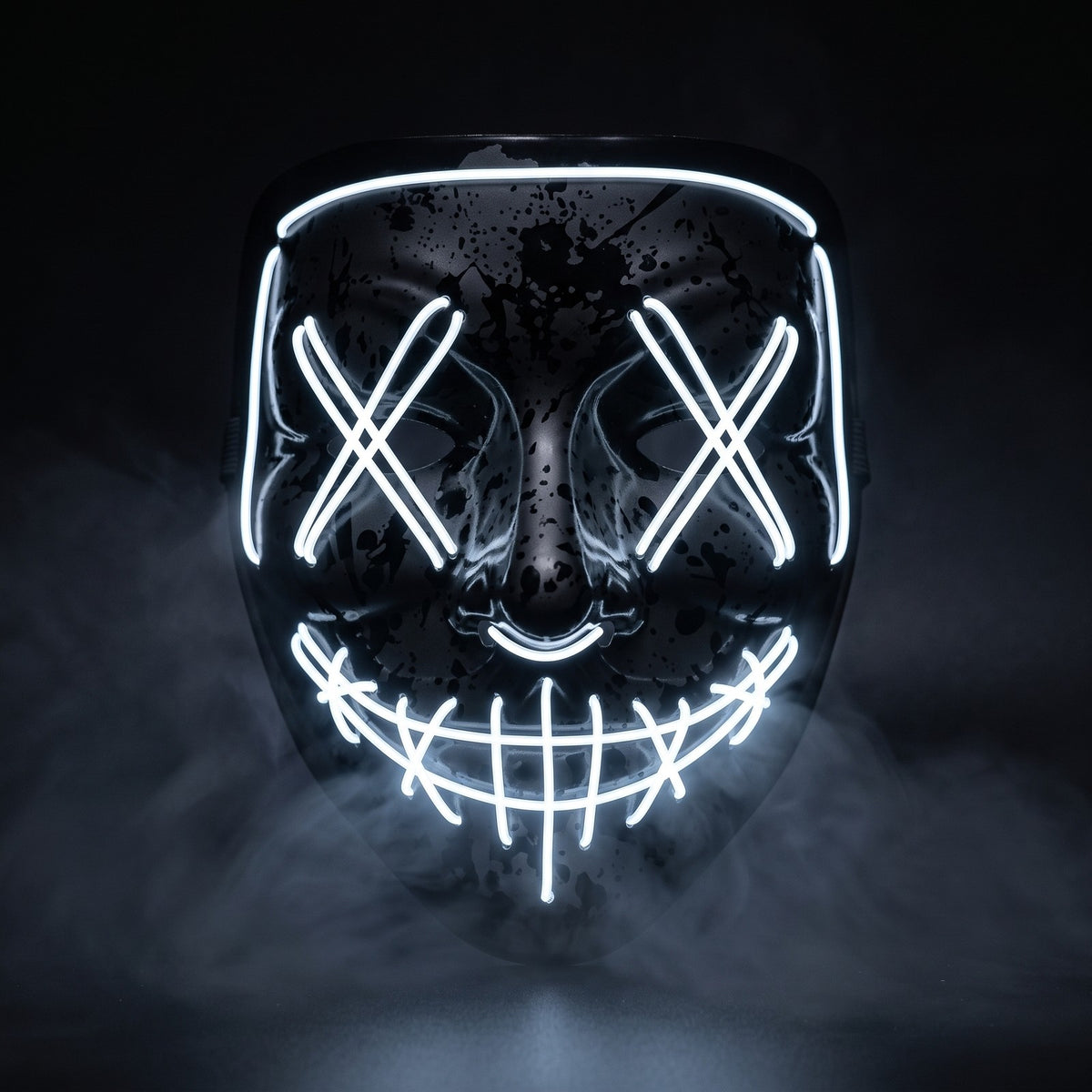 Black splatter shell X-eye LED mask glowing white in the smoke