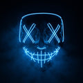X-eye LED mask glowing blue in smoke