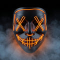 X-eye LED mask glowing orange in smoke